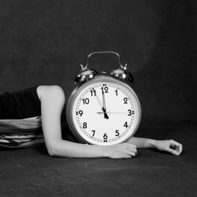 Girl with big alarm clock